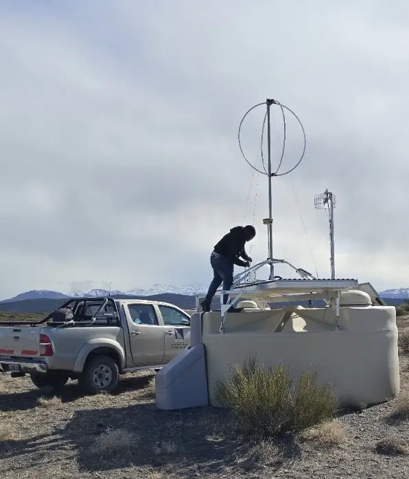 Fieldwork on a radio antenna above a surface detector at the Pierre Auger Observatory.